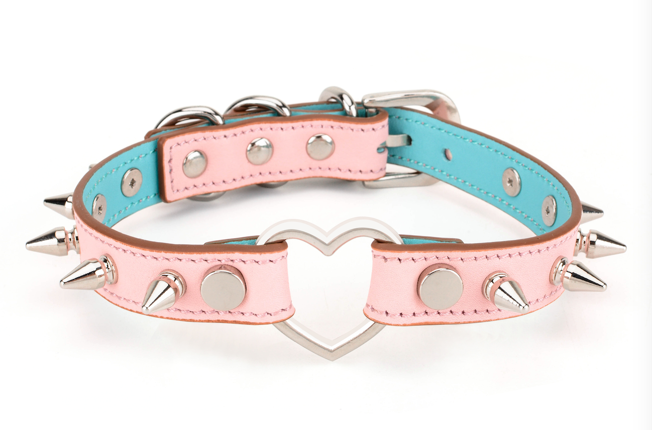 a pink spiked collar choker