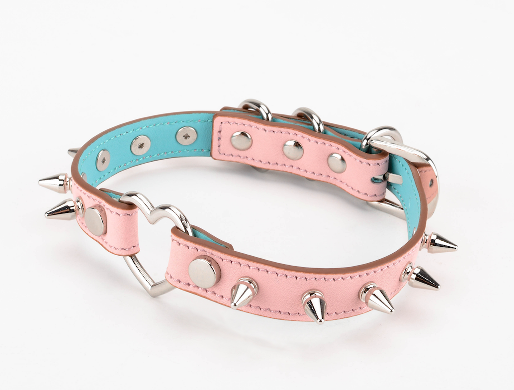 a pink spiked collar choker