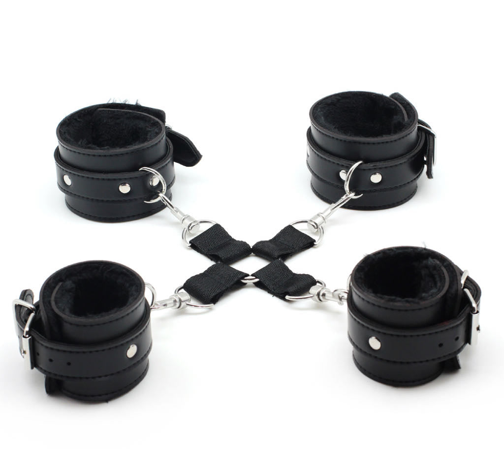 a set of black bondage cuffs with hogtie