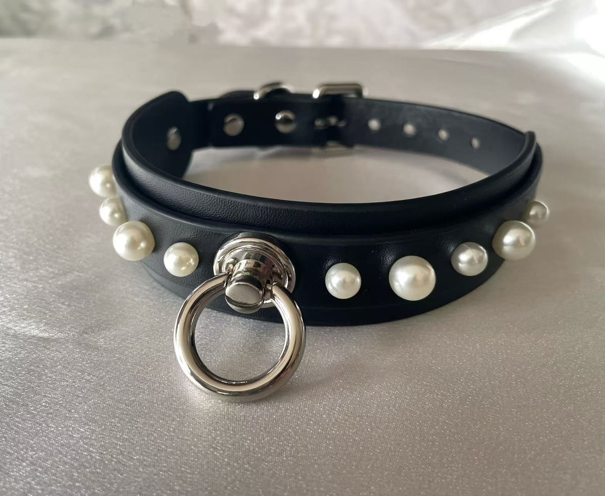 black faux leather collar studded with white pearls and central silver o ring
