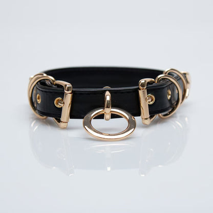 black faux leather o ring collar choker with polished gold alloy buckles on model neck front view