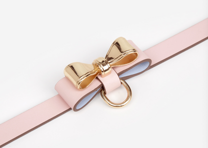 a pink sex collar and leash with bow