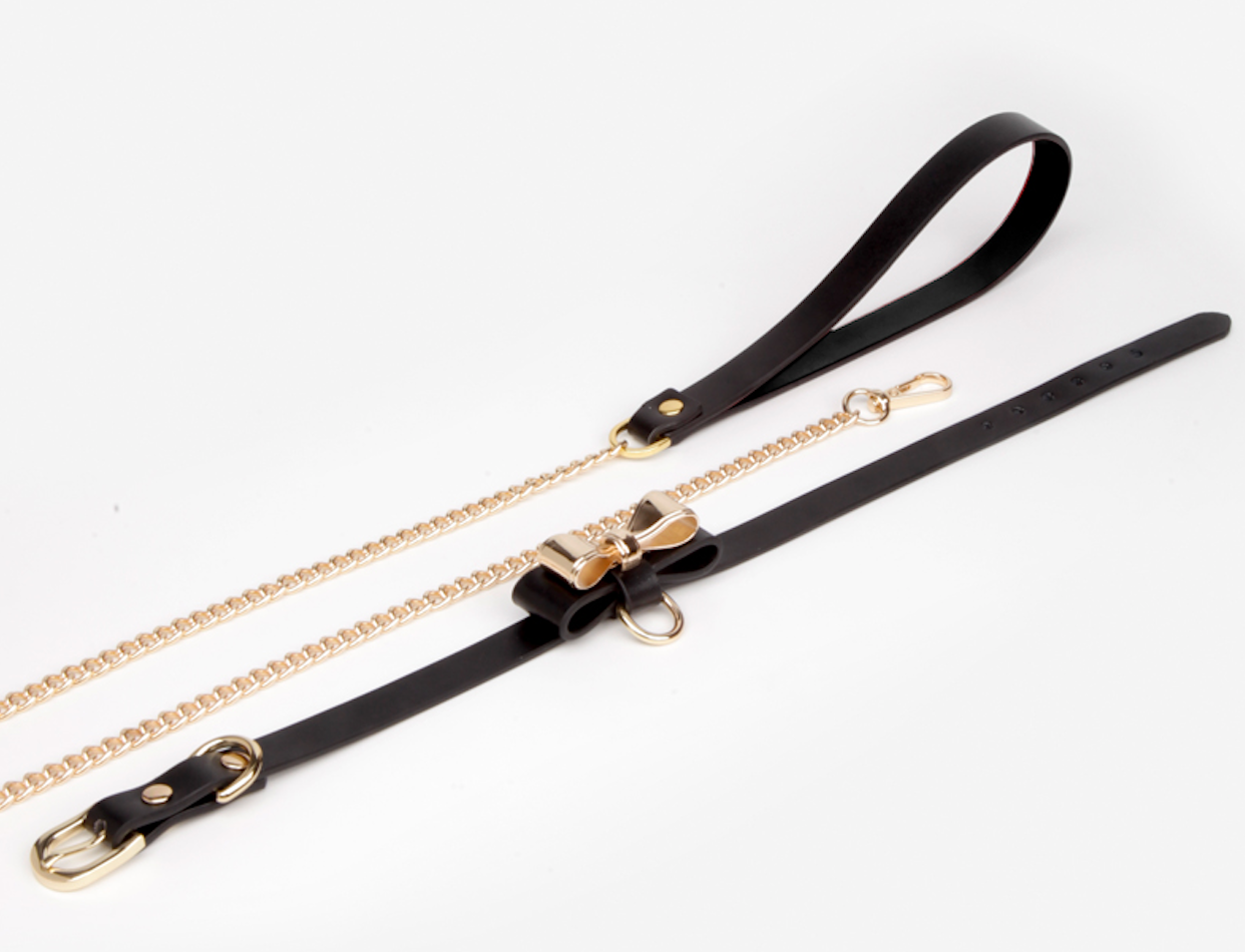 a black sex collar and leash with bow