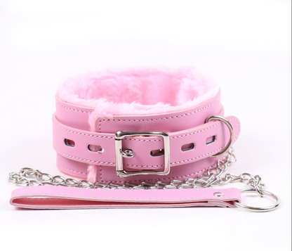 a pink bdsm collar and leash set