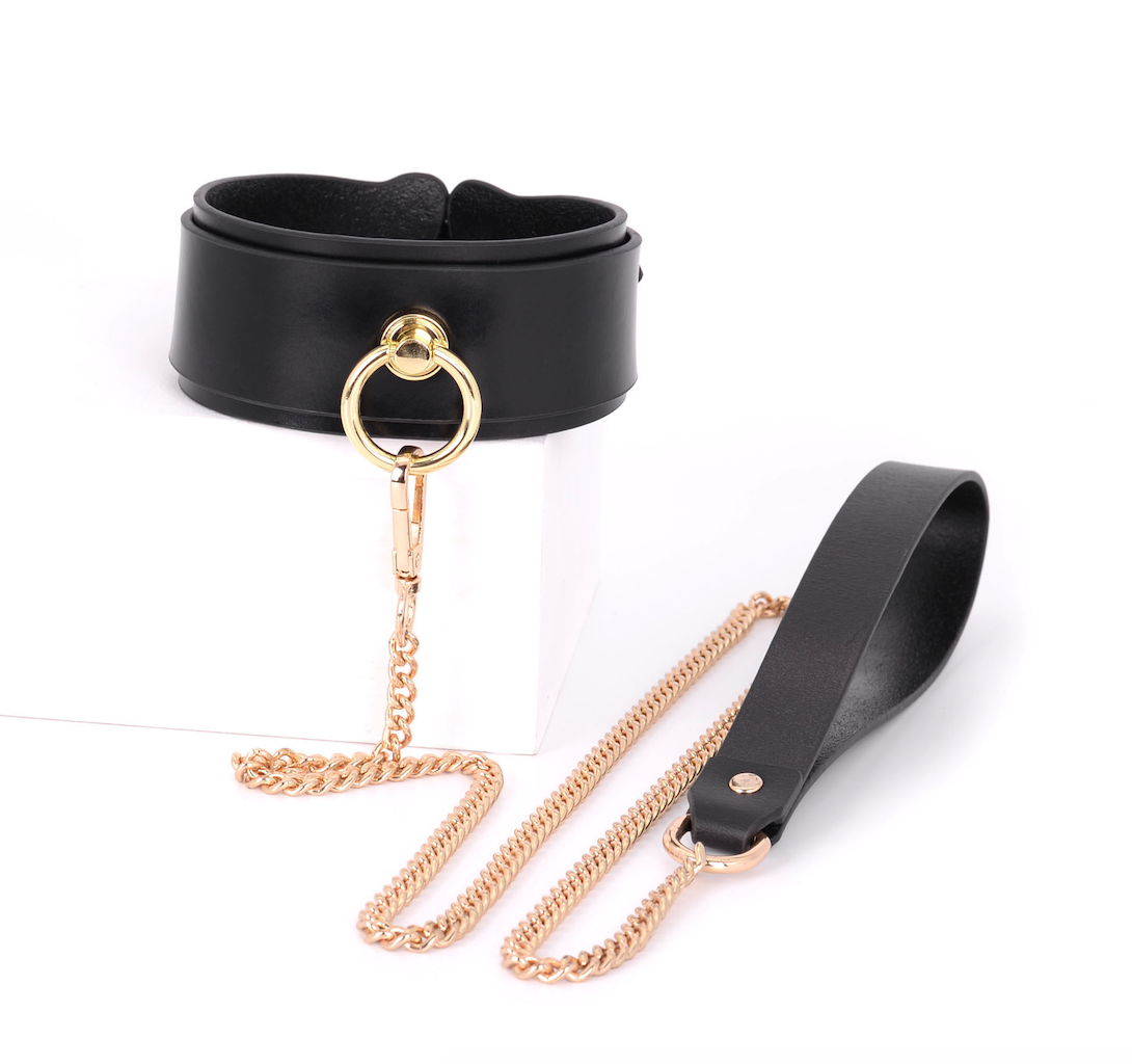 a black leather bondage collar and leash set