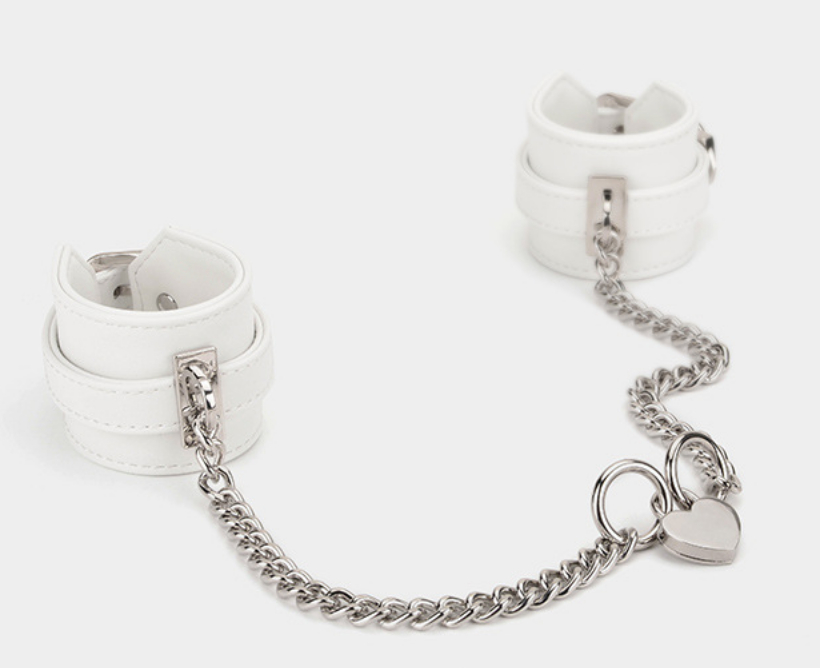 A pair of white Sex Handcuffs with heart lock and chain