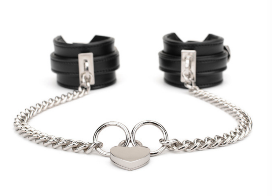 A pair of Black Sex Handcuffs with heart lock and chain