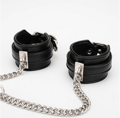 A pair of Black Sex Handcuffs with heart lock and chain