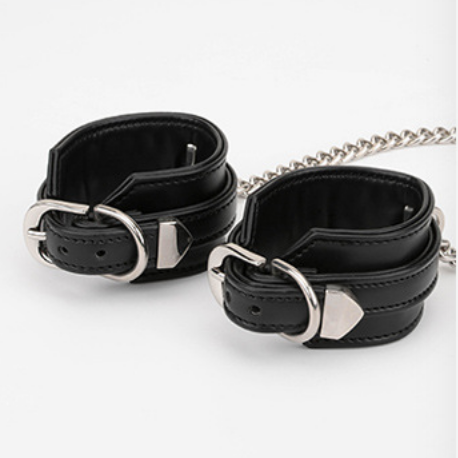 A pair of Black Sex Handcuffs with heart lock and chain