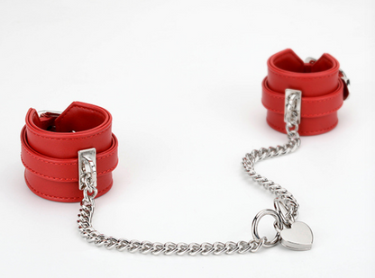 A pair of red Sex Handcuffs with heart lock and chain