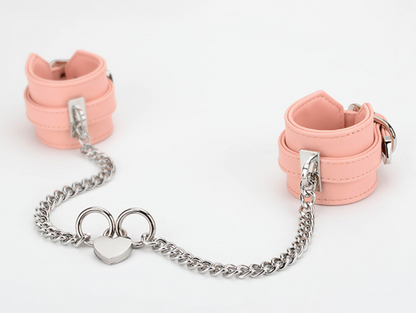 A pair of pink Sex Handcuffs with heart lock and chain