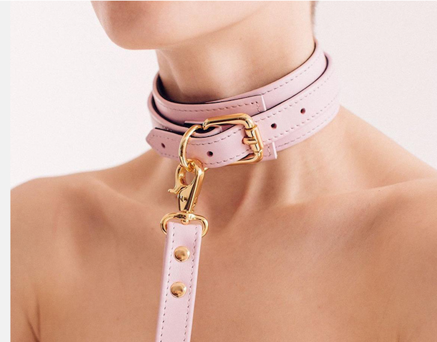 a pink leather collar and leash for women